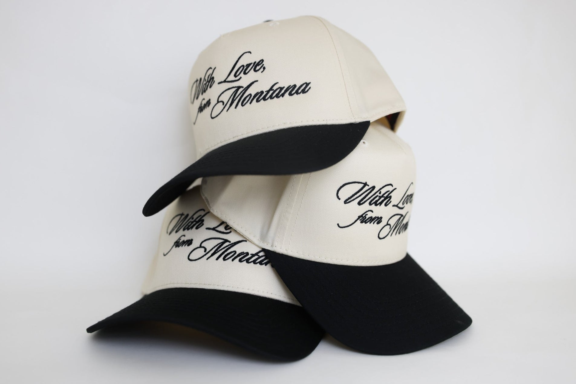Three baseball caps with 'With Love From Montana' text on a white background. Custom embroidered wedding hat.