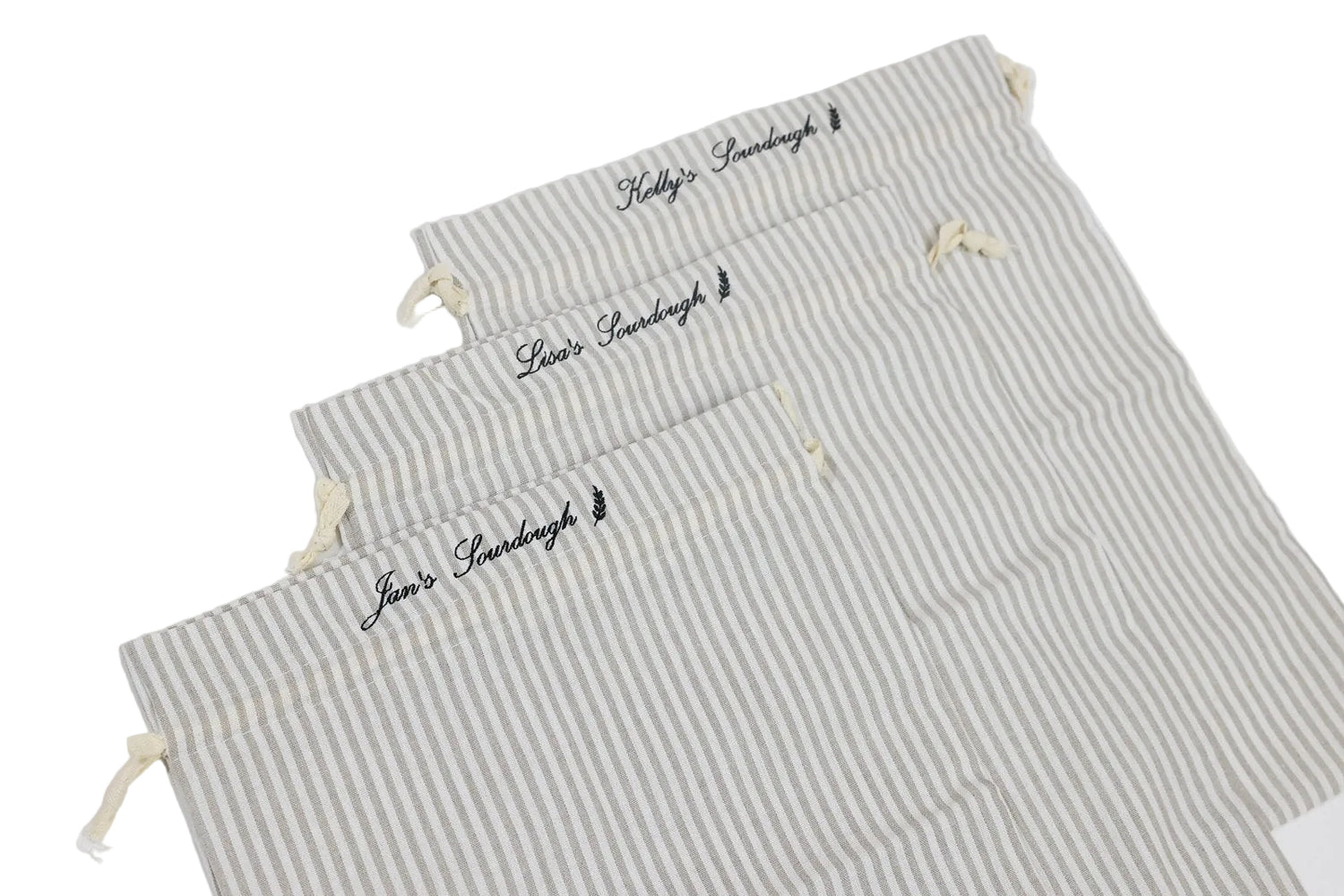 Set of three striped bags with embroidered text on a white background. custom embroidered sourdough bag.
