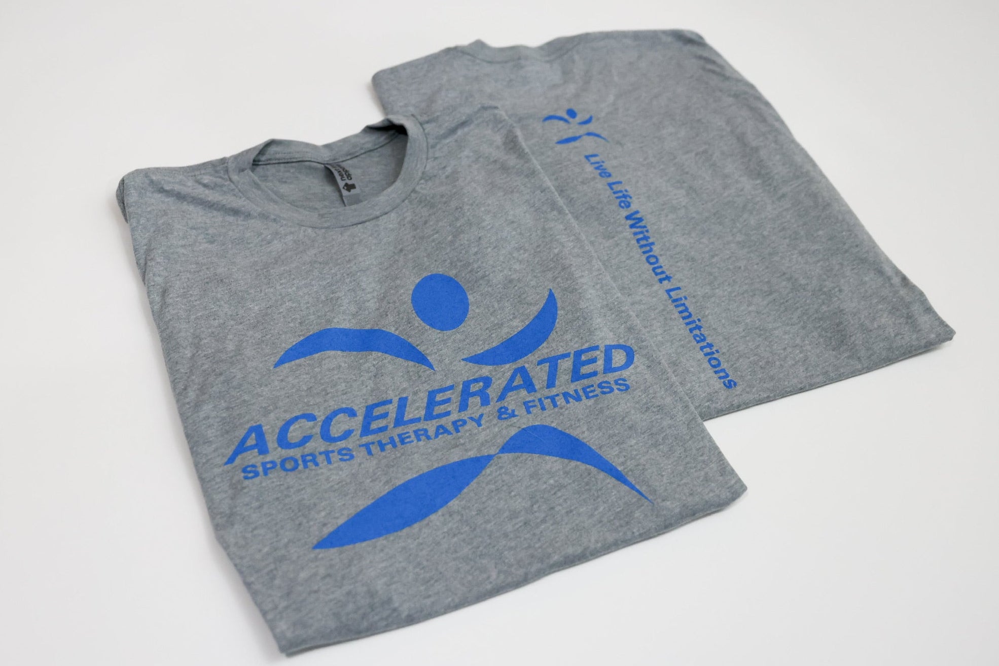 Gray t-shirt with blue 'Accelerated Sports Therapy & Fitness' logo on a white background