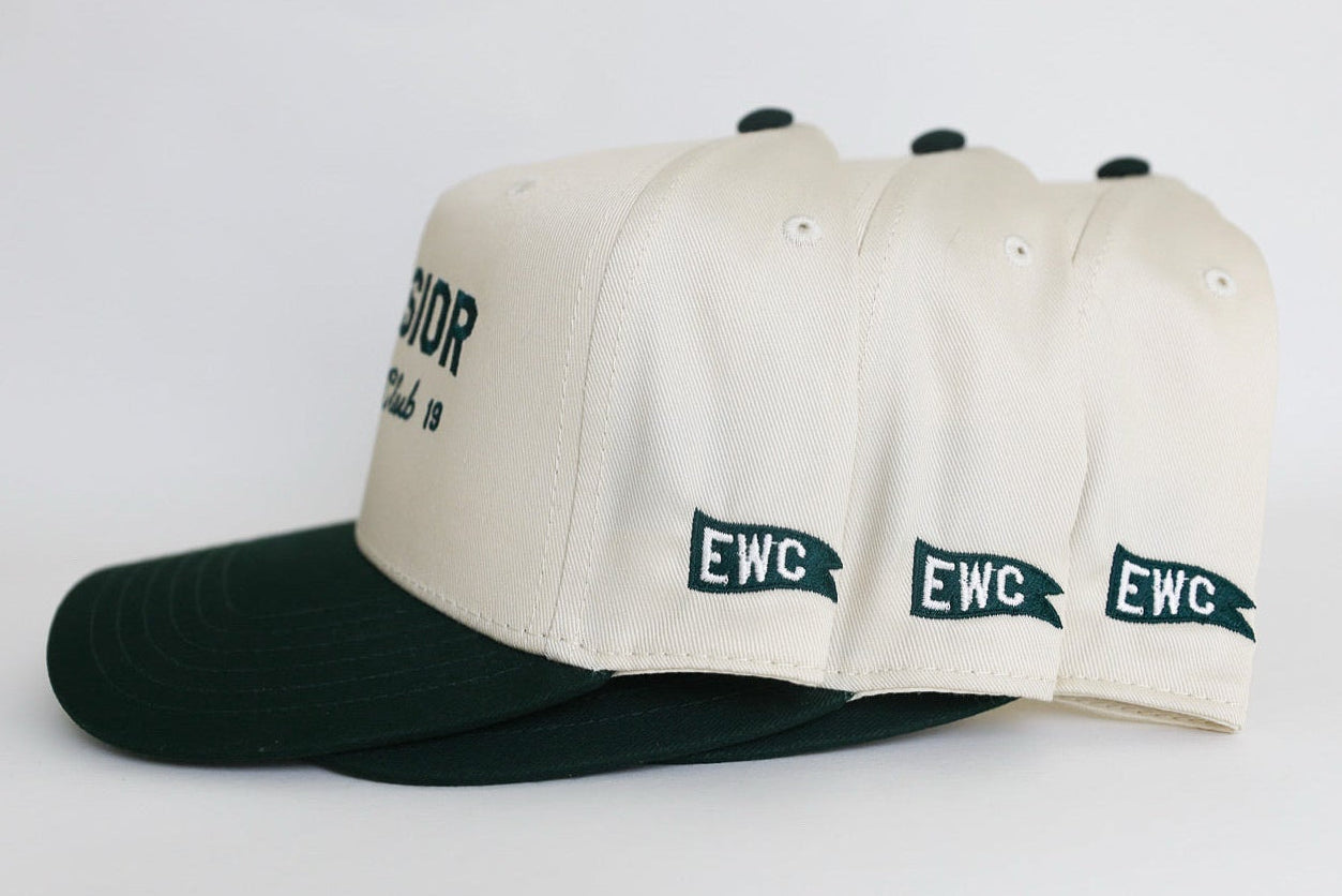 Three caps with 'EWC' embroidered branding on a white background