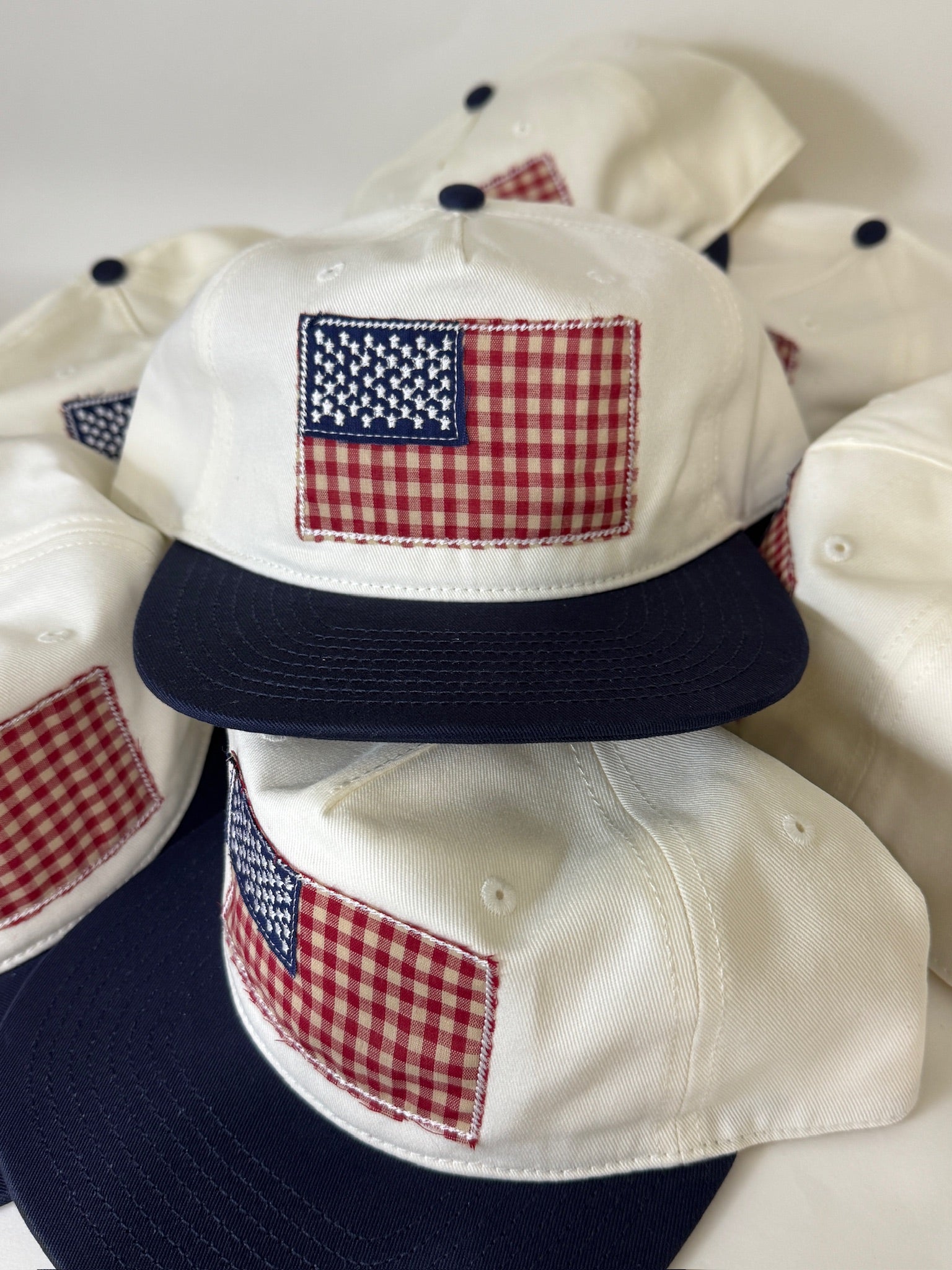 White baseball caps with American flag patches on a white background