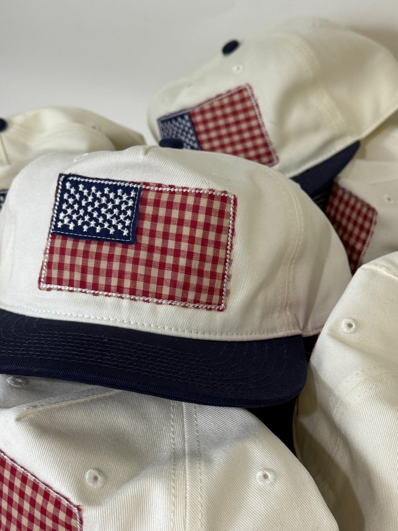 White baseball caps with American flag patches on a white background